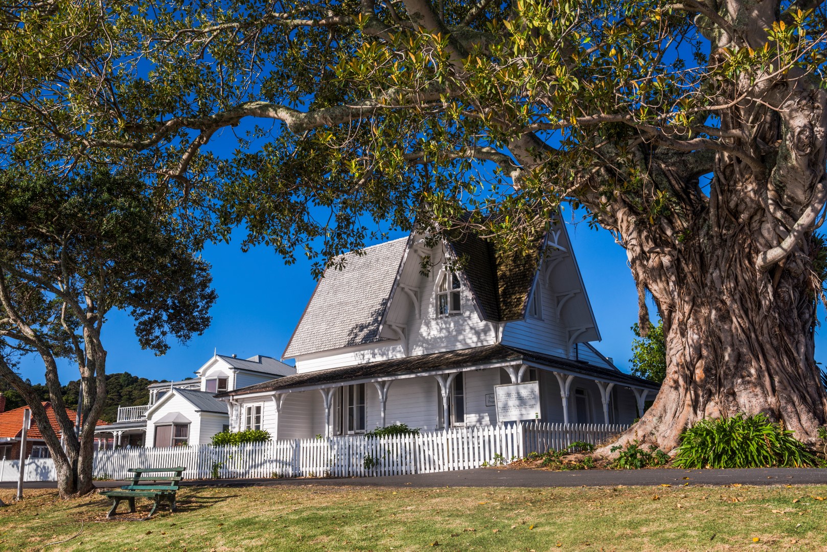 white picket fence, white house, big yard