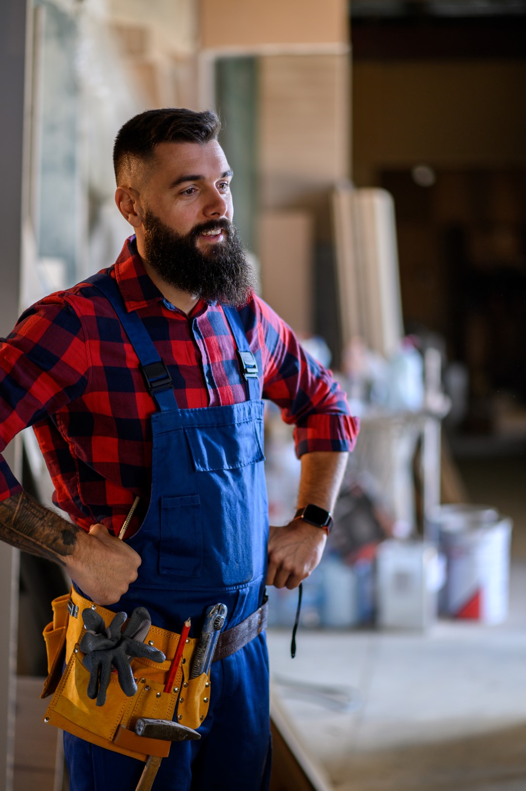 Worker in overalls and tool belt